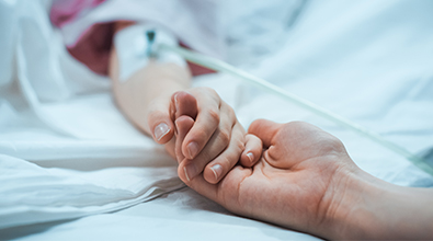 Tanner Hospice Care holding hand of patient. 